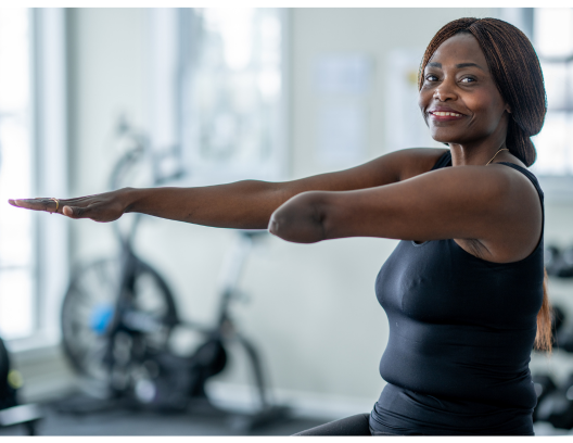 Elderly black female amputee exercising in a gym